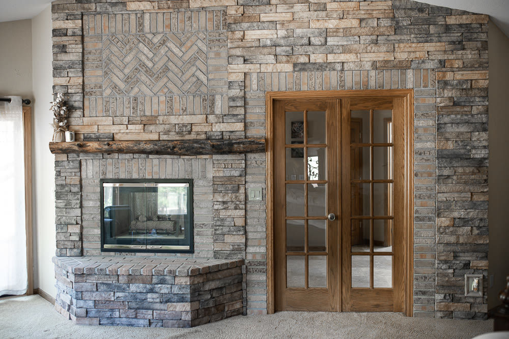 Stone wall with fire place and wood door