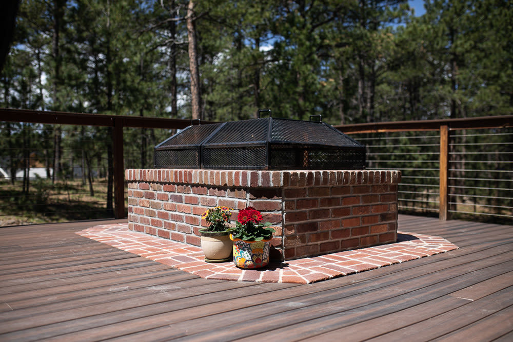 brick fire pit with flowers