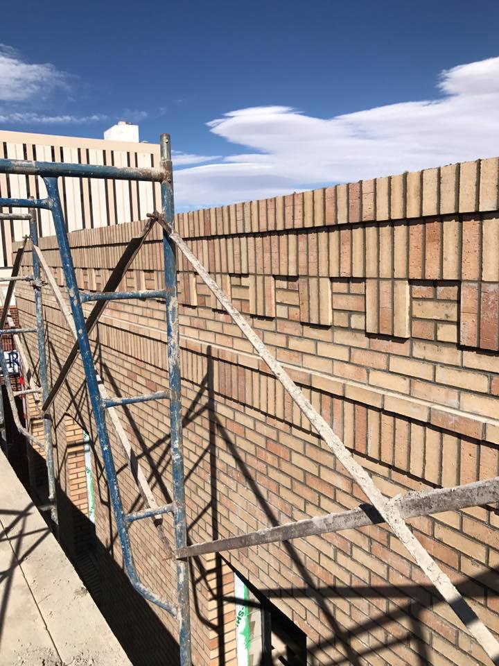 work site featuring laid bricks with scaffolding